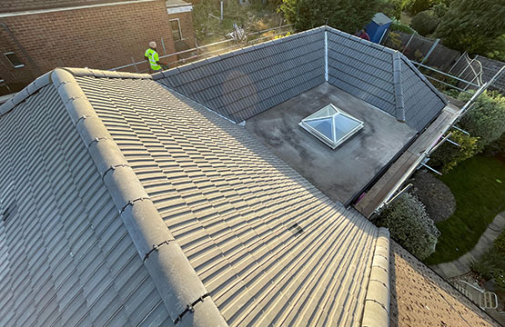 Roof repair work on a tiled home